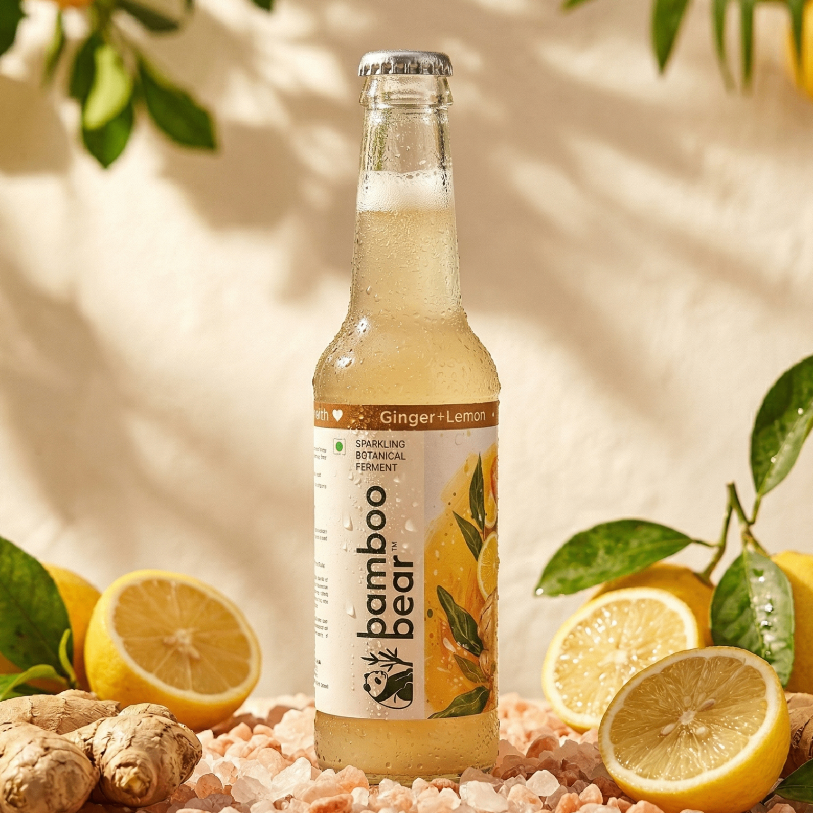 Bamboo Bear Ginger and Lemon bottle with lemons, ginger, and green leaves.